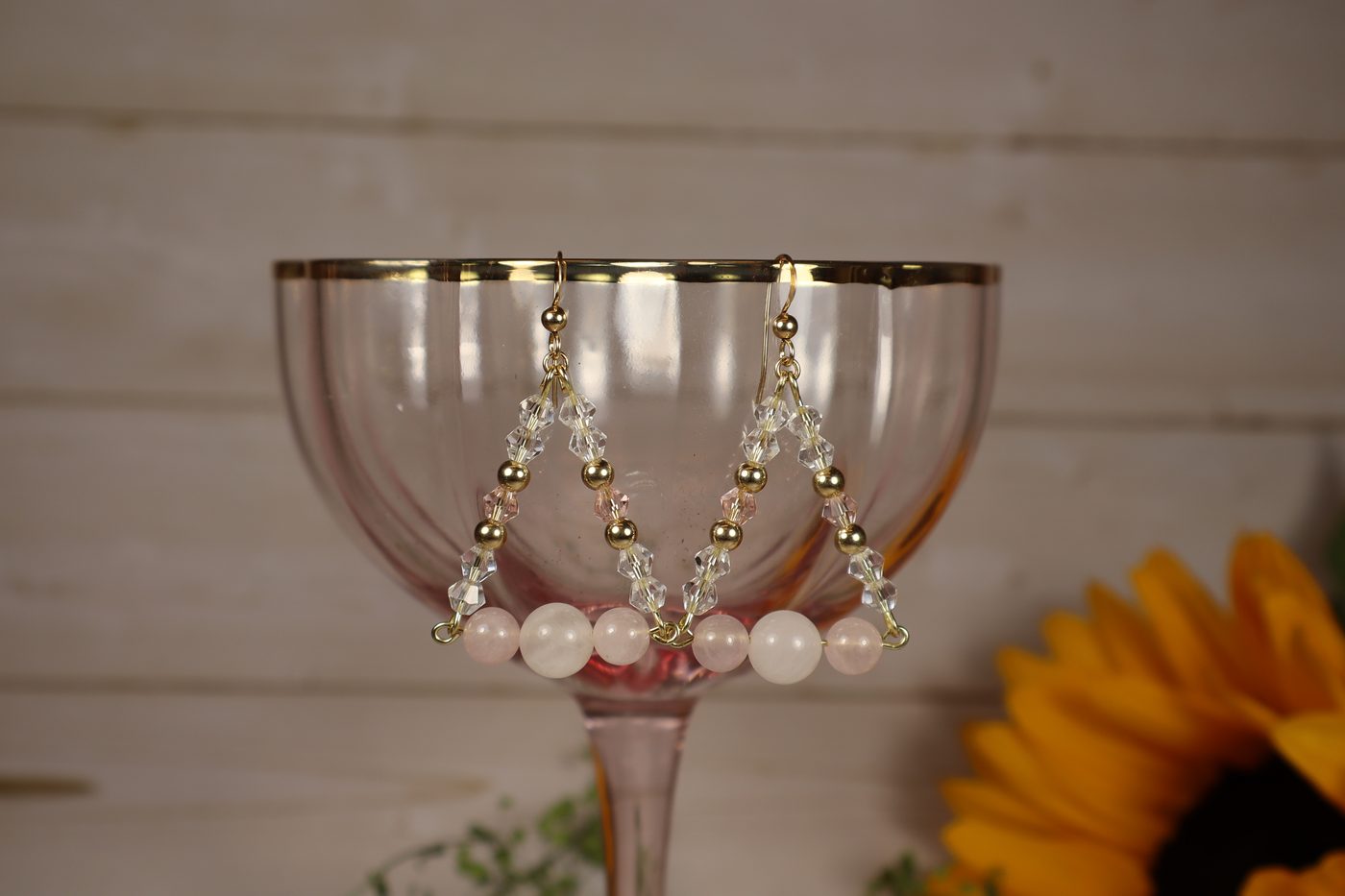 Rose quartz and crystal beaded triangle drop earrings on a vintage pink glass