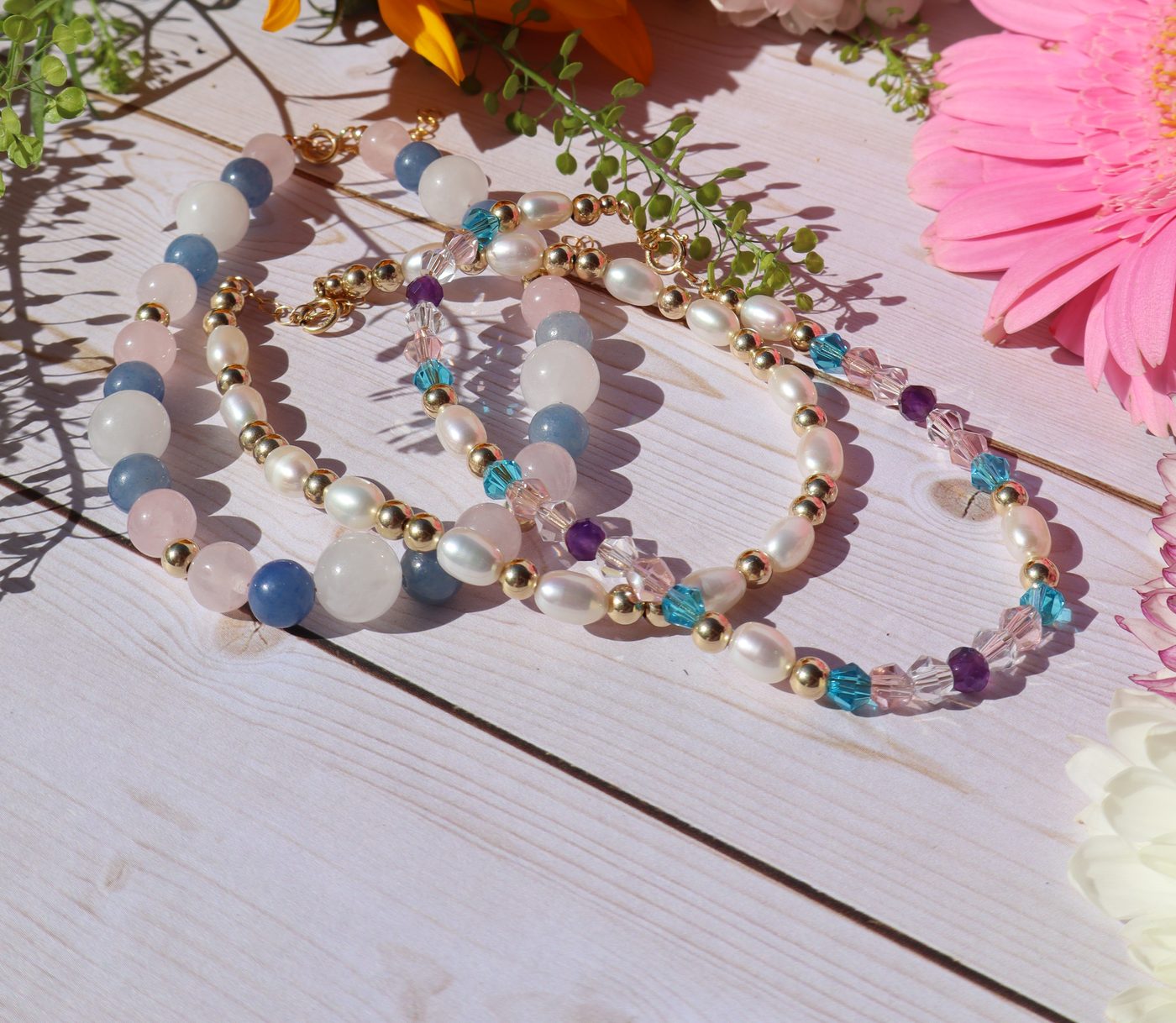 Sunflowers and pink daisies flat lay with House of Haliya handmade gold-filled jewelry